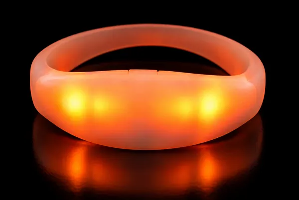 The elastic LED bracelet, a frosted silicone band glowing amber