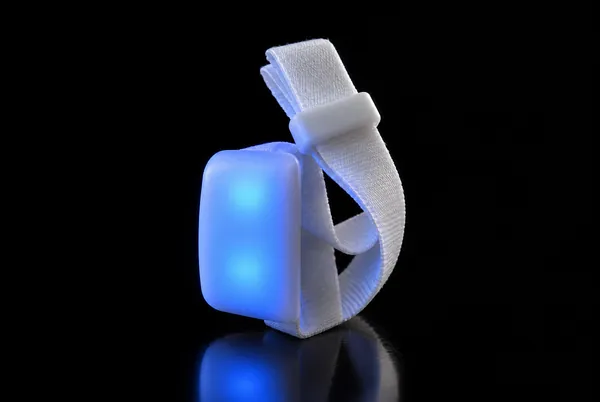 The rechargeable LED wristband: a white nylon strap with a rectangular LED unit lit blue