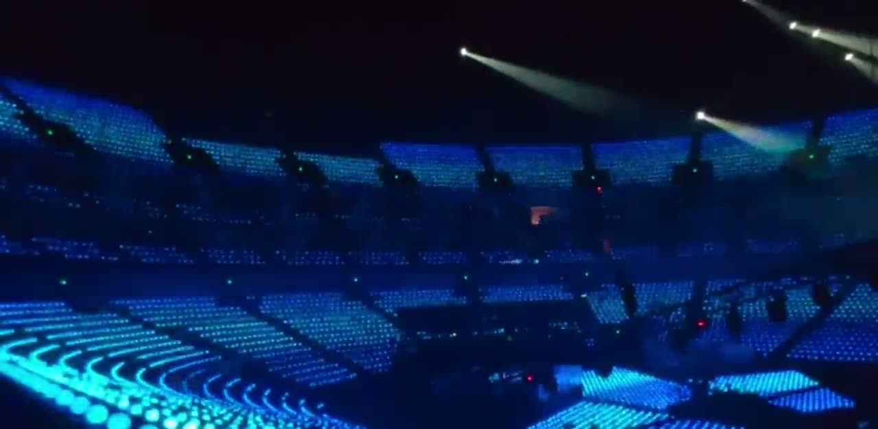 A stadium with every seat lit in blue by LED wristbands